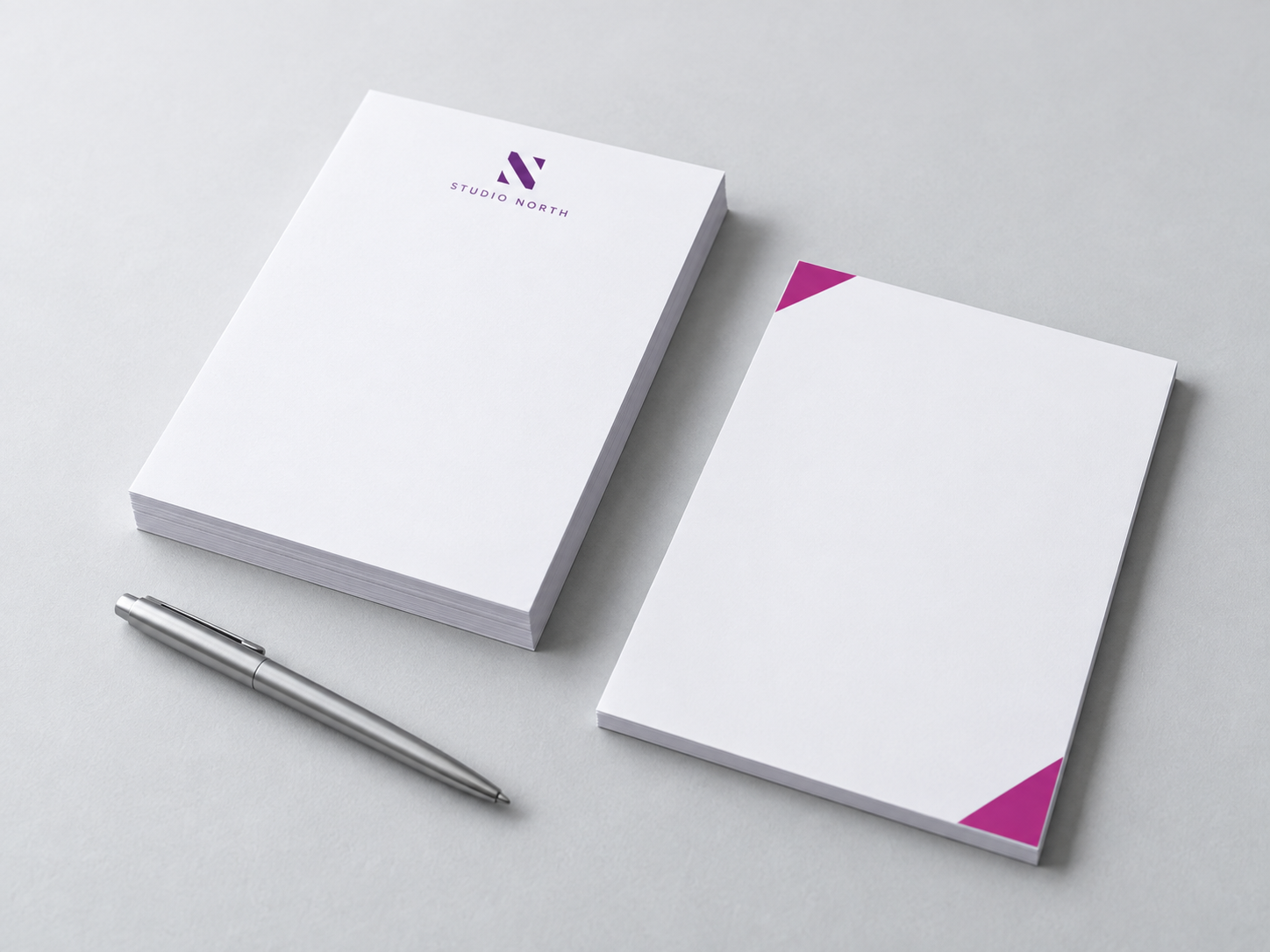 Custom white notepads with purple and magenta branding